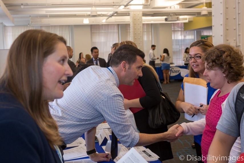 Man shaking hands with female at a career fair