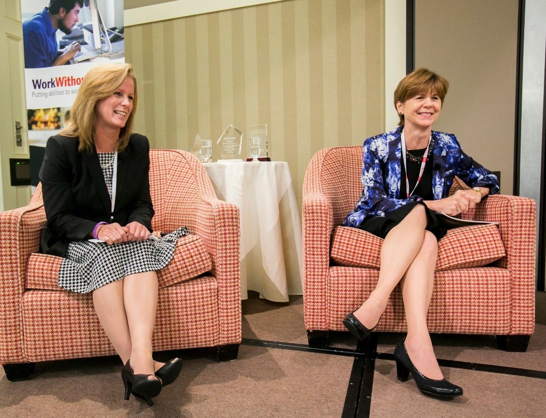 Kathy Petkauskos and Alexis Henry sitting in chairs on stage at the 2013 Raise the Bar HIRE conference