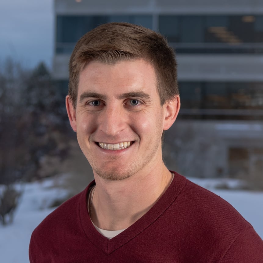 young white man with brown hair smiling
